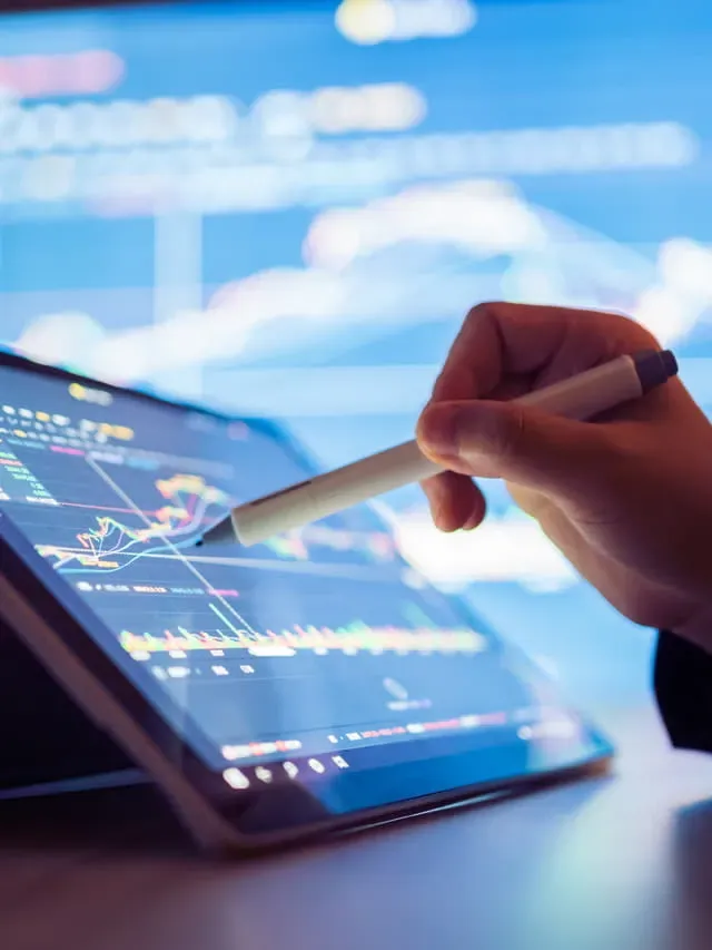 Trader using a stylus on a tablet