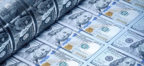 US Dollar notes being printed illustrating an example for a FOREX.com trading academy course on inflation